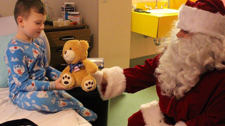 Santa delivers a teddy bear to a child in the QEII hospital after arriving via STARS helicopter, December 2019. (Michael Lumsden, MyGrandePrairieNow.com Staff)
