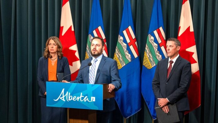 Alberta Education Minister Demetrios Nicolaides speaks at a news conference with Finance Minister Nate Horner and Premier Danielle Smith on Sept. 30, 2025